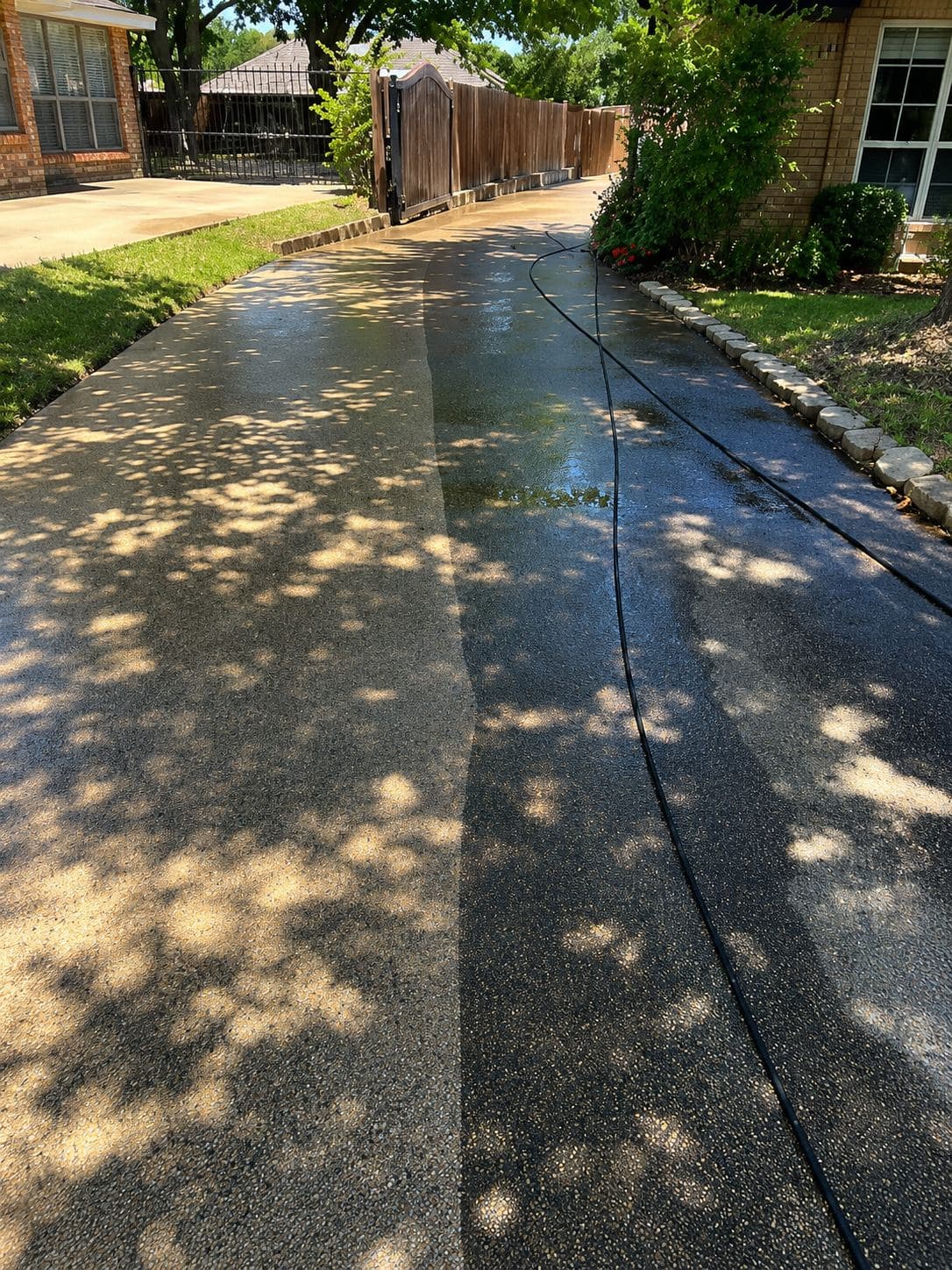 Driveway showing a stark contrast between a clean, light side and a dirty, dark side.